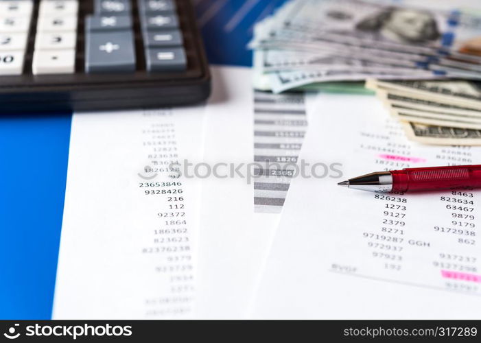 Business and financial background with dollars, charts, pen and calculator. Economy trends background for business idea and all art work design. Abstract bookkeeping background.. Business and financial background with dollars, data, pen and calculator. Bookkeeping background.
