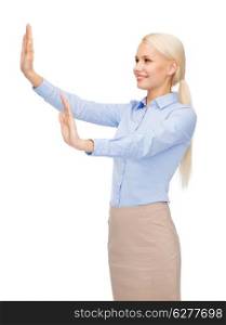 business and future technology concept - smiling businesswoman pointing to something or pressing imaginary button
