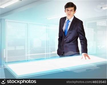 Business and high-tech innovations. Image of young businessman looking at high-tech picture