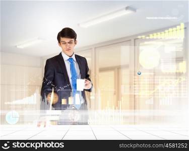 Business and innovation technologies. young businessman looking at graph of high-tech image