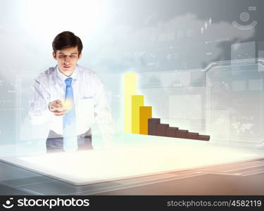 Business and innovation technologies. young businessman looking at graph of high-tech image