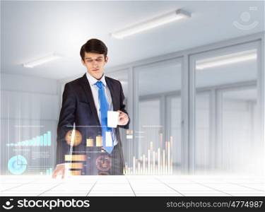 Business and innovation technologies. young businessman looking at graph of high-tech image