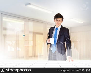 Business and innovation technologies. young businessman looking at graph of high-tech image