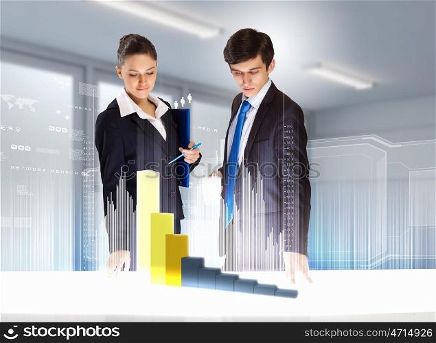 Business and innovation technologies. young businesspeople looking at graph of high-tech image