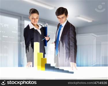 Business and innovation technologies. young businesspeople looking at graph of high-tech image