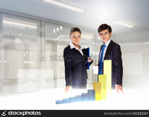 Business and innovation technologies. young businesspeople looking at graph of high-tech image