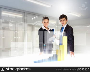 Business and innovation technologies. young businesspeople looking at graph of high-tech image