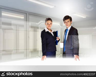 Business and innovation technologies. Young busuinesspeople standing against high-tech image background