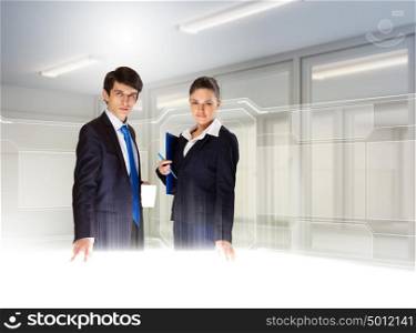 Business and innovation technologies. Young busuinesspeople standing against high-tech image background