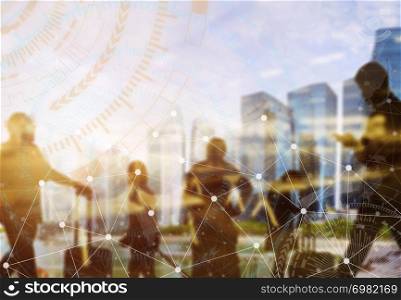 Business and modern technology concept. Double exposure of silhouetted people in city with wireless connection icons. Global communication.