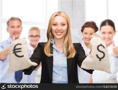 business and money - businesswoman holding money bags with dollars