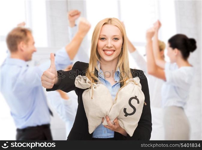 business and money concept - businesswoman with money bags showing thumbs up
