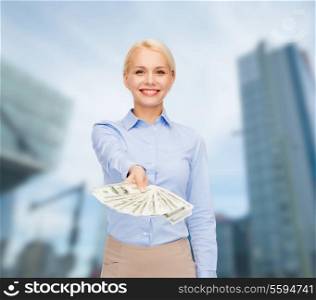 business and money concept - smiling businesswoman with dollar cash money