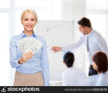business and money concept - smiling businesswoman with dollar cash money