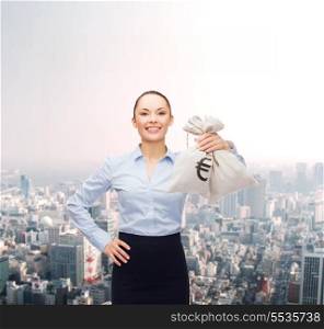 business and money concept - young businesswoman holding money bags with euro