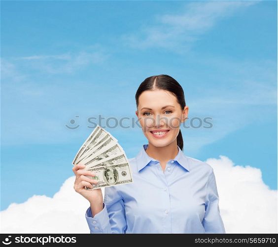 business and money concept - young businesswoman with dollar cash money over blue sky with white cloud background