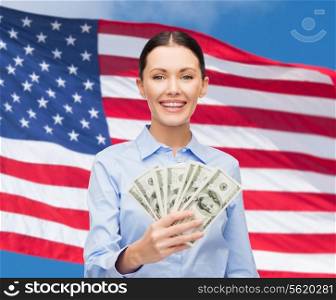 business and money concept - young businesswoman with dollar cash money over american flag background