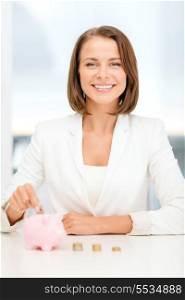 business and money saving concept - smiling businesswoman putting euro coins into piggy bank