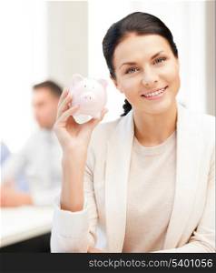 business and money saving concept - woman with piggy bank