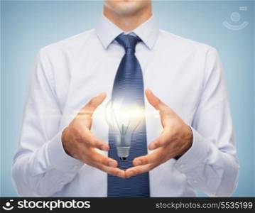business and office, advertising, people concept - friendly young buisnessman holding something in his hand