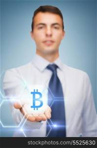 business and office, advertising, people concept - friendly young buisnessman showing bit coin sign on the palm of his hand