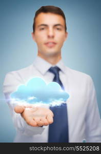 business and office, advertising, people concept - friendly young buisnessman showing cloud on the palm of his hand