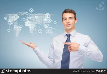 business and office, advertising, people concept - friendly young buisnessman showing map and network on the palm of his hand