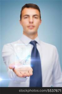 business and office, advertising, people concept - friendly young buisnessman showing transparent phone on the palm of his hand