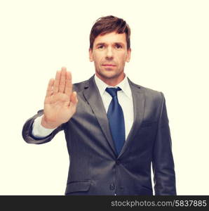 business and office, ban, veto, warning concept - attractive buisnessman making stop gesture