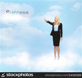 business and office - businesswoman pointing at success word in the sky