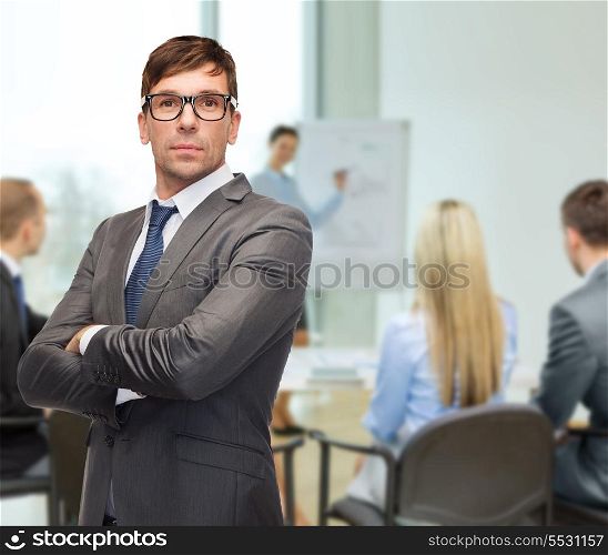 business and office concept - attractive buisnessman or teacher in eyeglasses at office