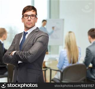 business and office concept - attractive buisnessman or teacher in eyeglasses at office
