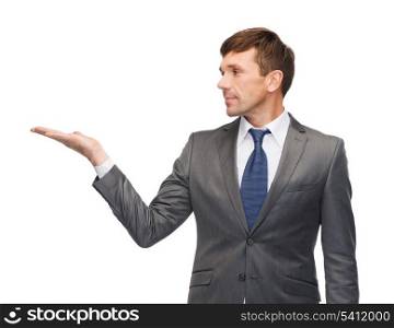 business and office concept - attractive buisnessman or teacher showing something on the palm
