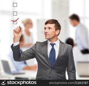 business and office concept - attractive buisnessman or teacher with marker