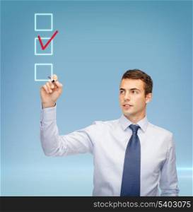 business and office concept - attractive buisnessman or teacher with marker drawing red checmark into checkbox