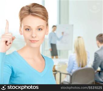 business and office concept - attractive young woman with finger up at office
