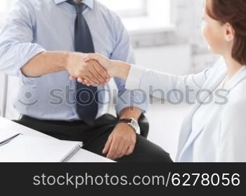 business and office concept - business people shaking hands in office