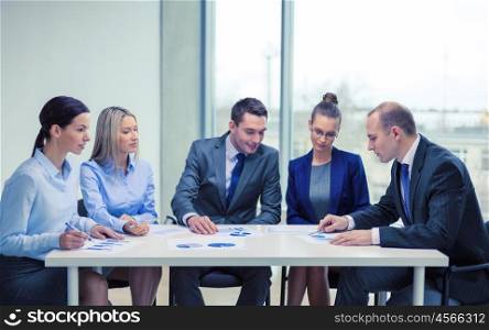 business and office concept - business team with documents having discussion in office. business team with documents having discussion