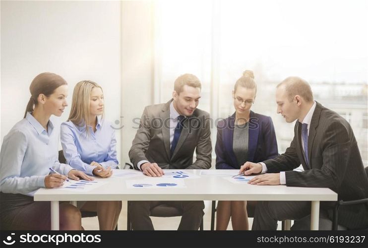 business and office concept - business team with documents having discussion in office. business team with documents having discussion