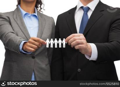 business and office concept - businessman and businesswoman holding paper team