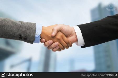 business and office concept - businessman and businesswoman shaking hands. businessman and businesswoman shaking hands