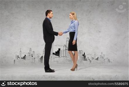 business and office concept - businessman and businesswoman shaking hands with city drawing in the back