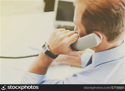 business and office concept - businessman talking on the phone