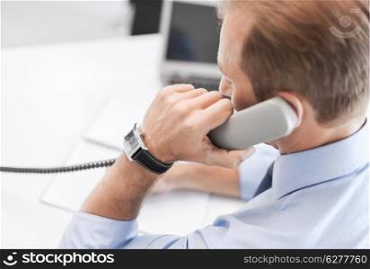 business and office concept - businessman talking on the phone