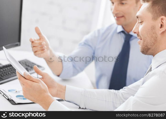 business and office concept - businessmen with notebook and tablet pc