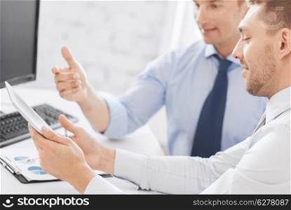 business and office concept - businessmen with notebook and tablet pc