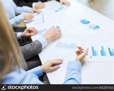 business and office concept - close up of business team with chats and graphs in office