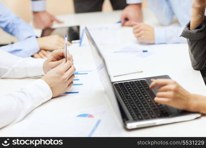 business and office concept - close up of business team with files and laptop computer in office