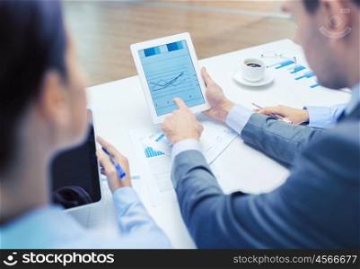 business and office concept - close up of business team with graph on tablet pc screen and coffee in office. business team with graph on tablet pc screen