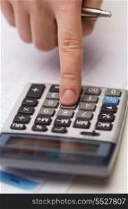 business and office concept - close up of businessman hand pressing calculator button